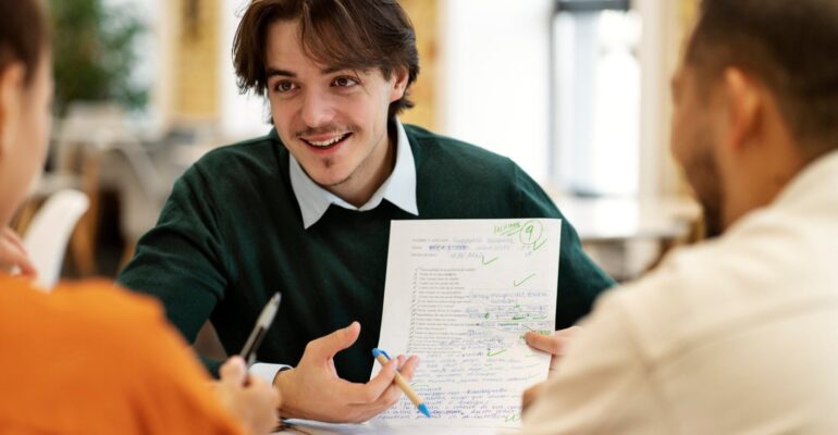 front-view-smiley-man-holding-paper-scaled-1